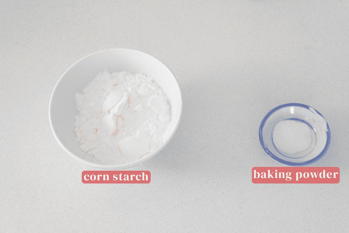 A bowl of corn starch and a dish of baking powder.
